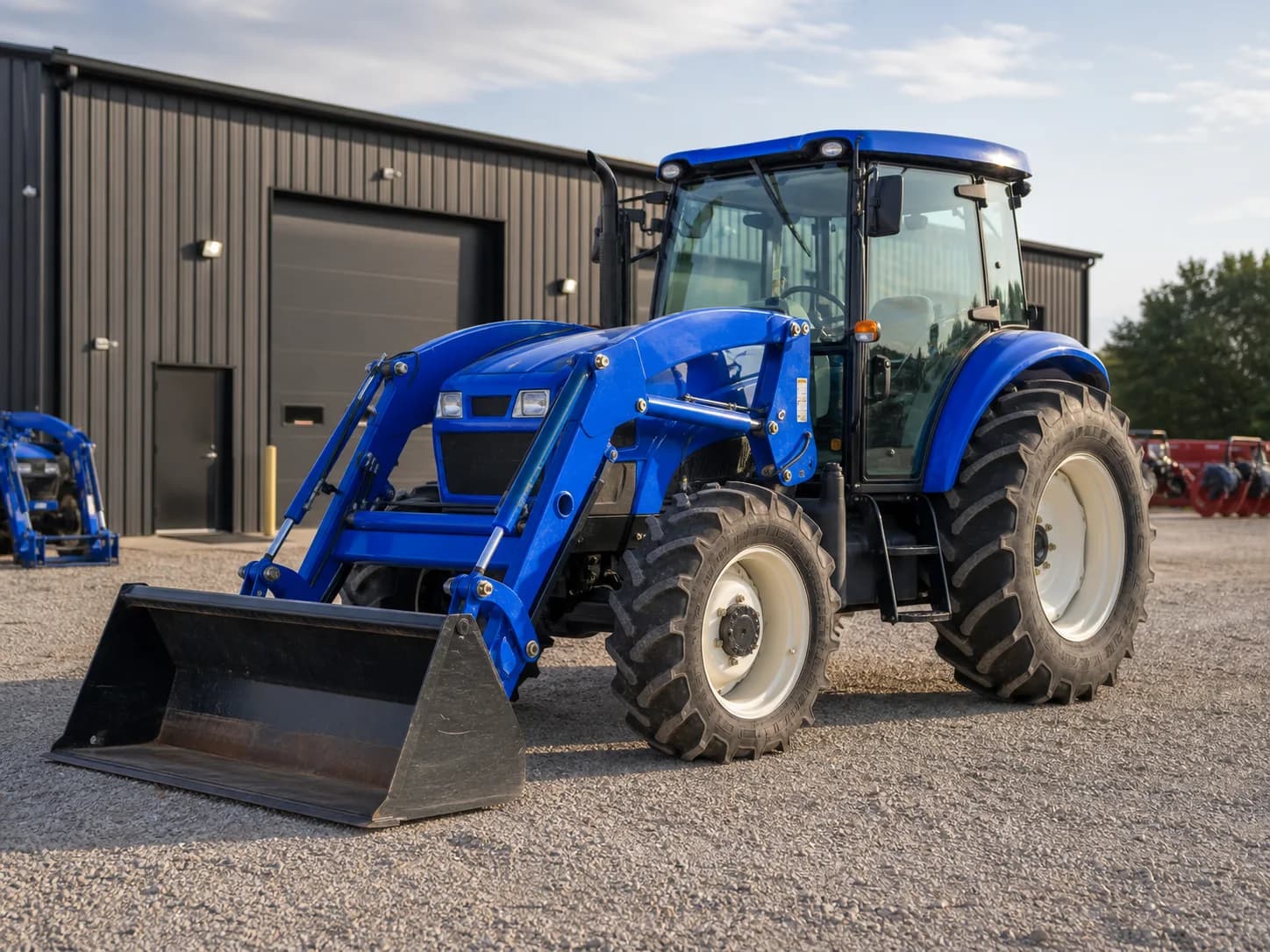 Blue loader tractor parked at an equipment dealership